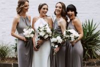 grey midi bridesmaid dresses with halter  necklines and draped bodices and silver shoes for a stylsh and elegant wedding