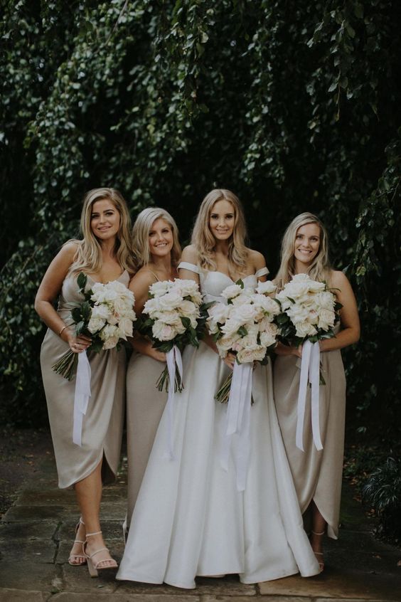 matching greige midi bridesmaid dresses with straps, white strappy shoes for a spring or summer wedding