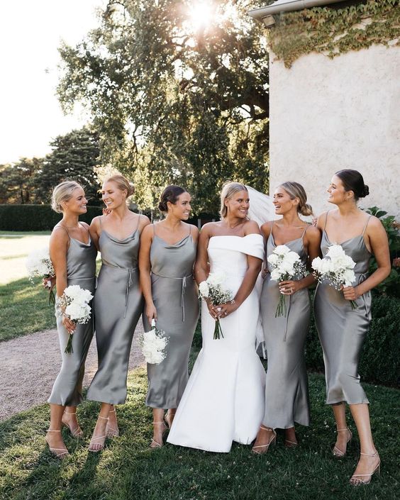 matching grey slip midi bridesmaid dresses with sashes and silver strappy shoes for a spring or summer wedding