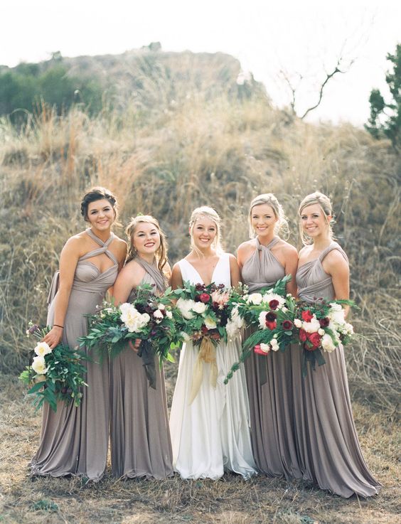 maxi grey bridesmaid dresses with mismatching necklines and pleated skirts are great for a summer or fall wedding