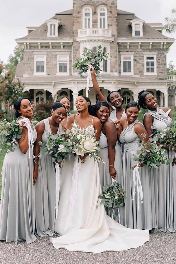mismatching dove grey maxi bridesmaid dresses with pleated skirts and draped bodices are adorable for a spring or summer wedding