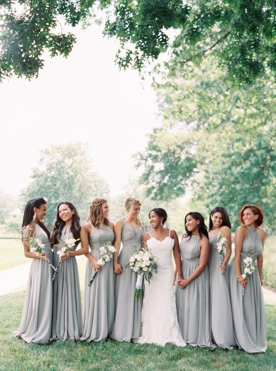 mismatching grey maxi bridesmaid dresses with pleated skirts and various necklines for a chic spring wedding