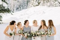 mismatching neutral and grey maxi bridesmaid dresses with pleated skirts and various detailing for a winter wedding