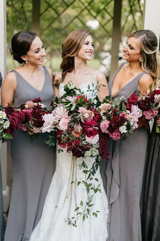 plain sheath bridesmaid dresses with deep neckline and thick straps and cascading pink and burgundy bouquets