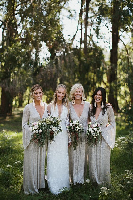 silver grey maxi bridesmaid dresses with deep necklines, bell sleeves and full embellishments, statement earrings for a boho wedding