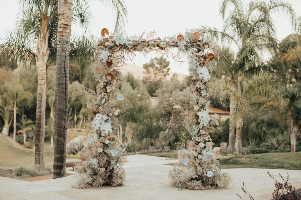The wedding arch was very lush, decorated with blooms, leaves and greenery