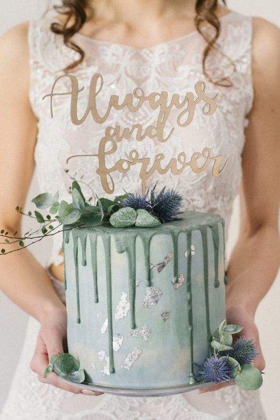 a mint green wedding cake with green drip, silver leaf, greenery, thistles is amazing for spring and summer