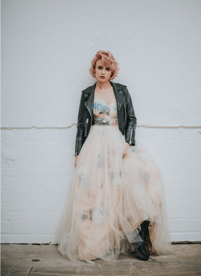a strapless floral wedding ballgown paired with a black leather jacket and black boots for a bad ass bridal look