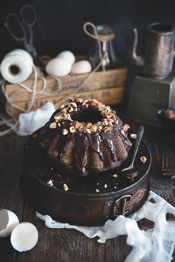 a chocolate bundt wedding cake with chocolate drip and nuts on top is a delicious idea for a casual wedding