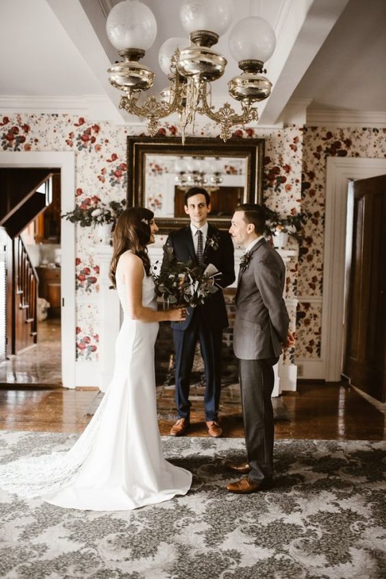 a cute and intimate at-home elopement with the ceremony right in the living room is a lovely idea