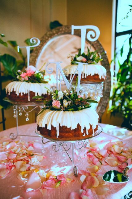three bundt wedding cakes with frosting and blooms plus monogram toppers are great for spring or summer