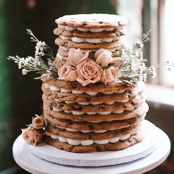 a cookie wedding cake with white and blush blooms is a lovely idea for a spring or summer wedding