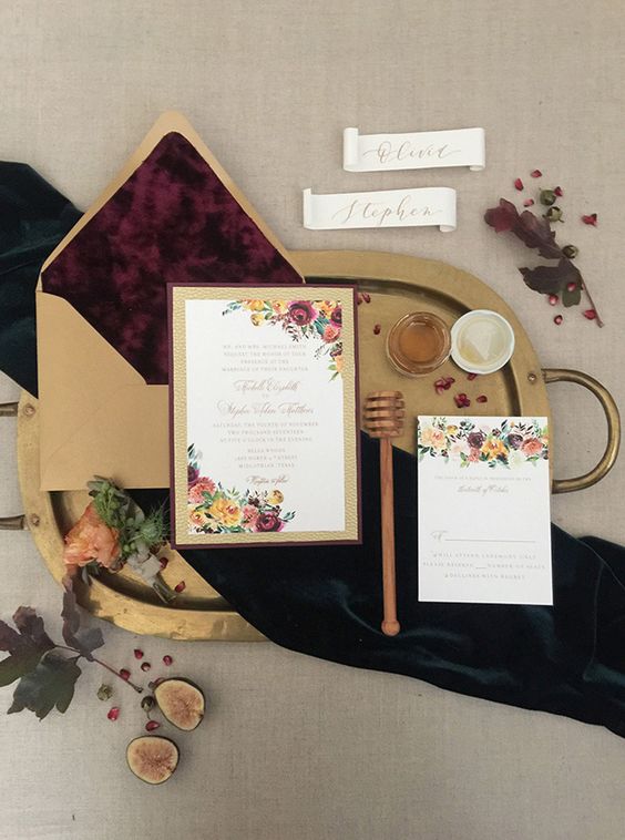 a refined winter wedding invitation suite with florals, gold glitter and a gold envelope with purple lining