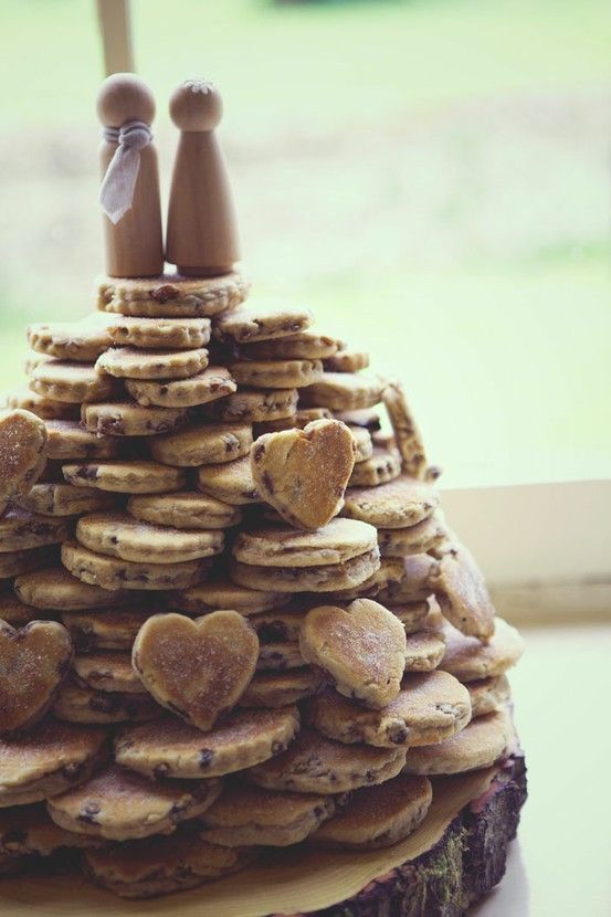 a homemade stacked heart-shaped cookie wedding cake with simple wooden toppers is a lovely idea for a rustic wedding