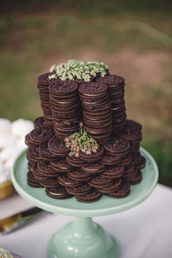 a simple Oreo cookie stacked wedding cake with some blooms is a lovely idea for a relaxed or laid back wedding
