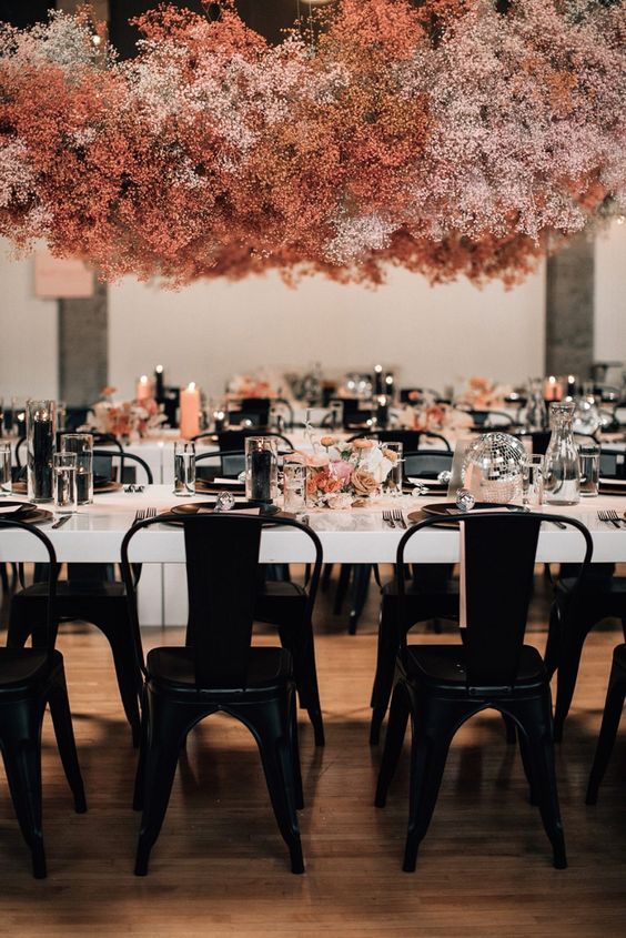 an orange, rust and blush baby's breath chandelier is a beautiful and bold idea for a modern reception space