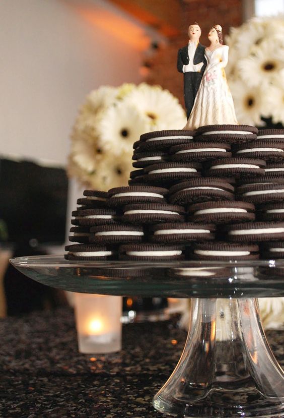 an Oreo cookie stacked weddin cake with traditional bride and groom toppers is a simple and lovely idea for any wedding