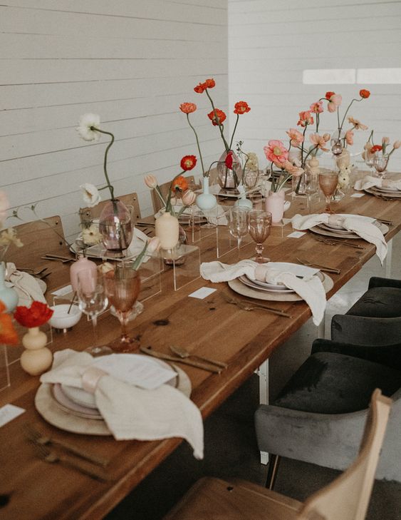a pretty cluster wedding centerpiece of neutral and pastel ases and coral, deep red and white blooms is chic