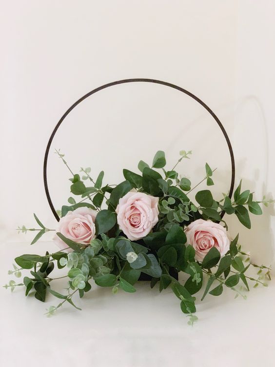 a pretty hoop wedding centerpiece of blush roses and greenery is an elegant and timeless idea for a tablescape