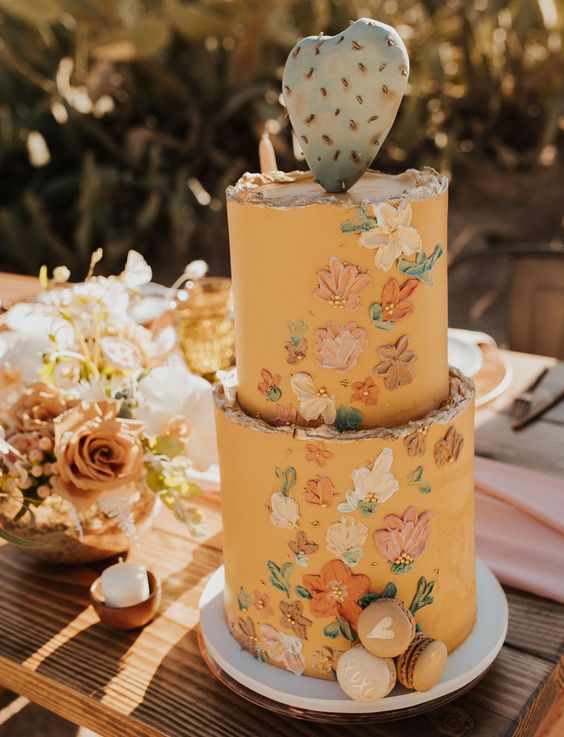 16 a honey yellow wedding cake with a rough edge, painted dimensional blooms and beads plus a cactus topper for a boho flower child wedding
