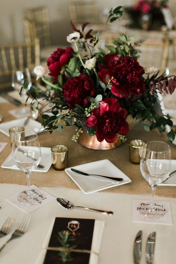 17 a sophisticated fall or winter wedding centerpiece with burgundy blooms, white ranunculus, greenery is amazing and beautiful