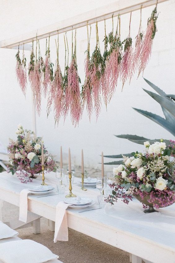 an overhead installation of pink astilbe and greenery is a very out of the box decor idea that will catch an eye
