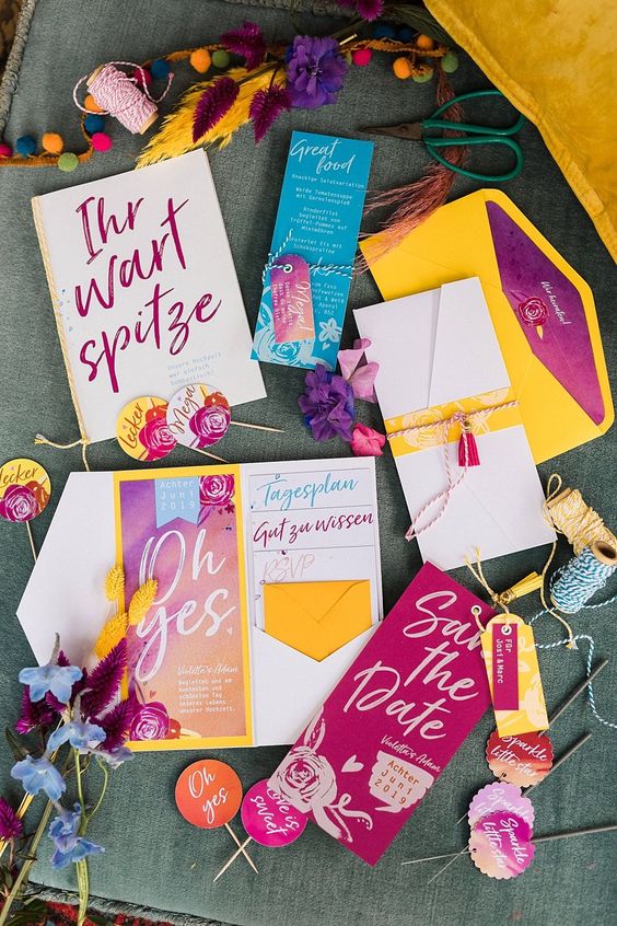 a super colorful and fun wedding invitation suite in bold yellow, fuchsia, hot pink and blue is a cool and bright idea to rock