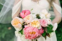 09 a bright wedding bouquet of peachy, pink and white peonies and peony roses plus greenery for a bold nautical wedding
