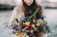 12 a bright nautical wedding bouquet with blue, purple, burgundy, yellow, pink and white blooms and greenery for a boho nautical bride