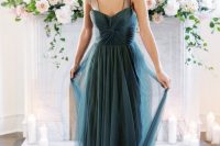 12 a grey blue wedding dress with a fitting wrap bodice and an A-line skirt, sheer thick straps and pleating is refined