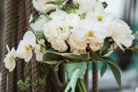 20 a gorgeous nautical wedding bouquet of white ranunculus and orchids, berries and greenery plus bright green ribbons