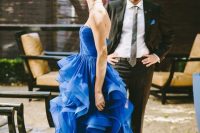 28 an electric blue wedding dress with a draped bodice and a tiered ruffle skirt with a train is a gorgeous statement