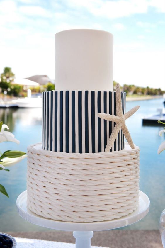 a chic nautical wedding cake with a white, a striped and a rope tier, a starfish is a lovely and non obtrusive idea for a seaside wedding