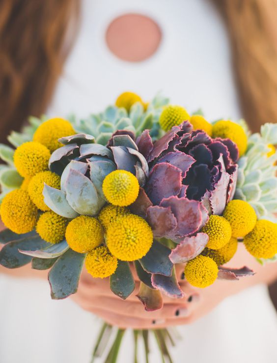 a cool wedding bouquet of billy balls and usual and dark succulents is a lovely idea for a mid century modern wedding