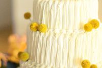 a cool white buttercream wedding cake decorated with billy balls is a lovely idea for spring or summer
