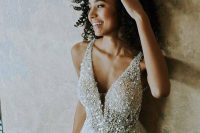 a glam A-line wedding dress with a sparkling bodice, thick straps and a layered skirt with a touch of sparkle is a gorgeous idea