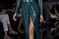 a jaw-dropping dark green sparkling wedding dress with a deep neckline, a thigh high slit and a silver star belt just wows