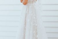 a lovely wedding ballgown with spaghetti straps and star appliques all over the dress plus an open back is an amazing idea