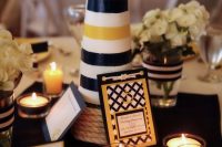 a nautical wedding centerpiece of a beacon, lots of candles and a bright table number is a gorgeous idea