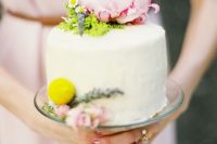 a one tier buttercream wedding cake with greenery, a pink peonyand a billy ball is a stylish and chic idea for spring or summer