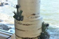 a semi-naked wedding cake with a rope tier, some greenery, an anchor and rope on top is a lovely and chic idea to rock