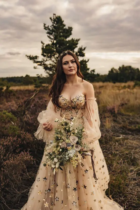 a strapless nude A-line wedding dress with puff sleeves, gold and silver foil stars and a fully embellished bodice for a gorgeous celestial wedding