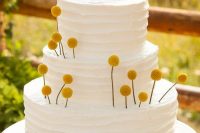 a white buttercream wedding cake with lots of billy balls inserted is a lovely and pretty idea to decorate a cake easily