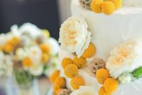 a white buttercream wedding cake with neutral peonies, seed pods and billy balls is a lovely and chic idea for a rustic wedding in spring or summer