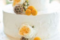 a white textural buttercream wedding cake with neutral blooms, billy balls and seed pods is a stylish idea for spring or summer