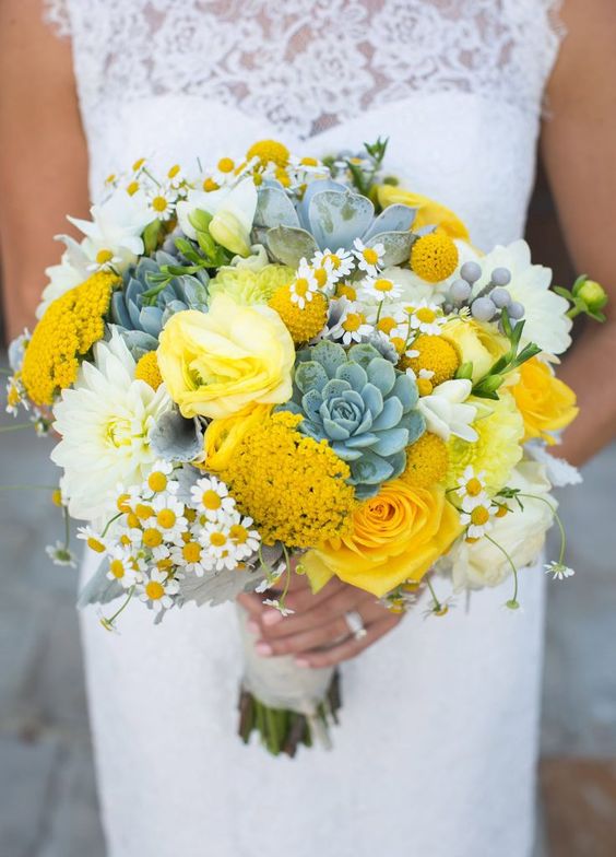 a bold summer wedding bouquet with succulents, yellow roses, mimosas, billy balls and pale foliage is wow