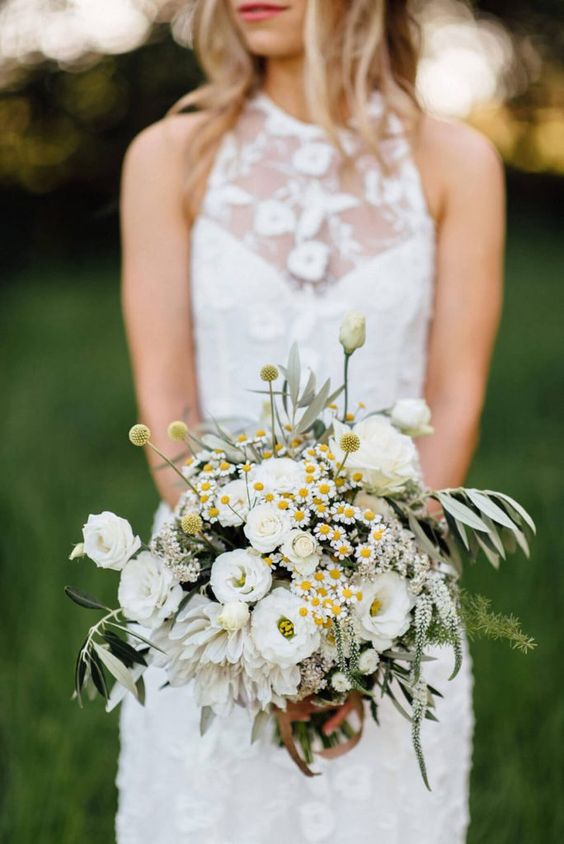 a pretty spring or summer wedding bouquet of white ranunculus, daisies, greenery and billy balls is a lovely idea