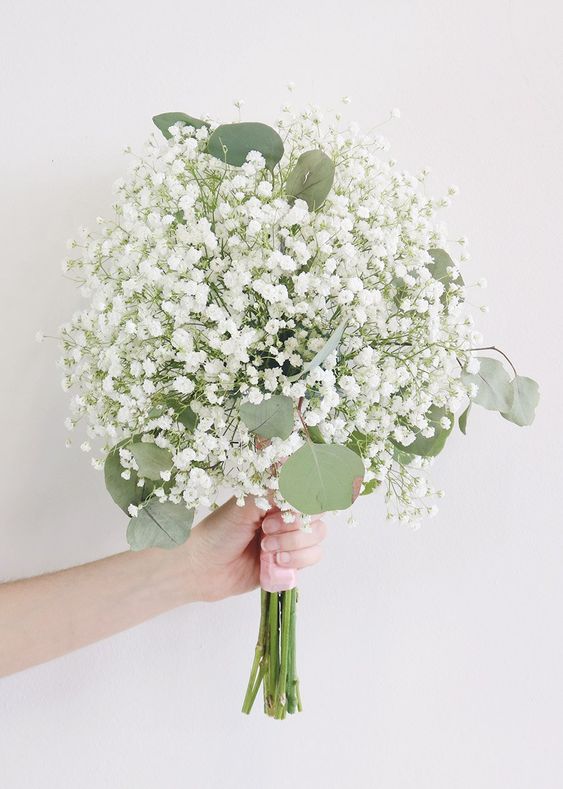 an easy and cool wedding bouquet of only baby's breath and eucalyptus is a lovely idea for any bride who wants something romantic