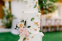 35 a refined secret garden wedding cake in white and with lots of pink and rust sugar blooms and petals plus sugar foliage