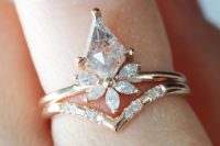 a beautiful stacked engagement ring with a large rhomb opal and diamonds and a lower triangle one with small diamonds